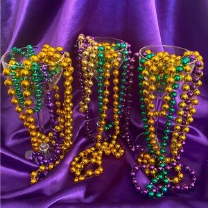 Mardi Gras beads decorate a Set of 3 Epic Acrylic Wine Glassware as fun display